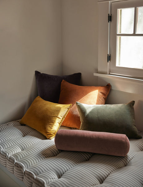 #color::moss #style::lumbar  #fill type::with-feather-down-insert  #fill type::pillow-cover-only |   Charlotte velvet pillow in mustard, burnt orange, warm gray, and moss sit together on a striped cushioned bench