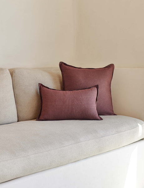 #color::aubergine #style::square #fill type::with-feather-down-insert #fill type::pillow-cover-only | The arlo Aubergine burgundy flax linen pillow in its lumber and square sizes sit together on a natural linen sofa