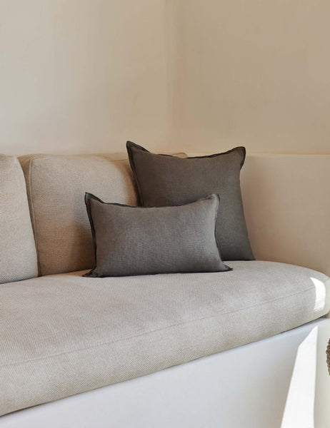 #color::conifer #style::square #fill type::with-feather-down-insert #fill type::pillow-cover-only | The arlo Conifer gray flax linen pillow in its lumber and square sizes sit together on a natural linen sofa
