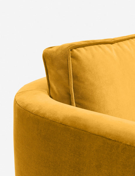 #color::goldenrod-plush-velvet | Close-up of the curved back on the Belmont goldenrod velvet accent chair
