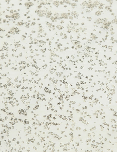 | Detailed view of the texture of the mirror ash glass top on the Bridget bronze pedestal side table