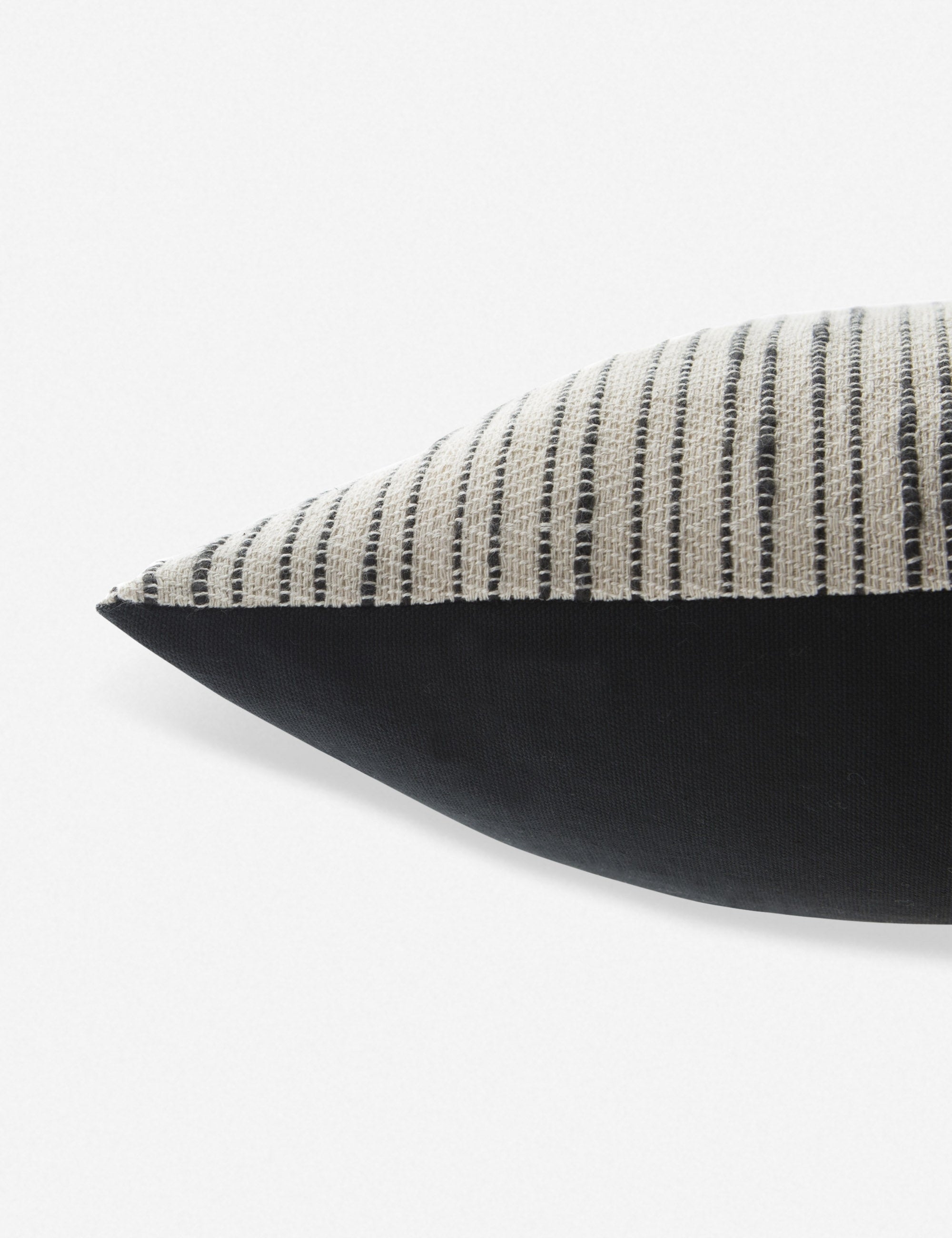Side view of the Peregrine black and white marled striped lumbar pillow