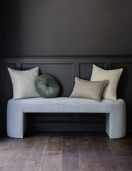#color::oatmeal #size::20--x-20- | The Manon linen oatmeal cream square boucle pillow sits on a light blue velvet bench with other throw pillows in a room with black accented walls