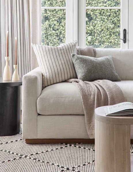  #color::slate #size::13--x-20- | The Manon linen slate gray lumbar boucle pillow sits on a gray linen sofa with other throw pillows in a living room with a black and white rug