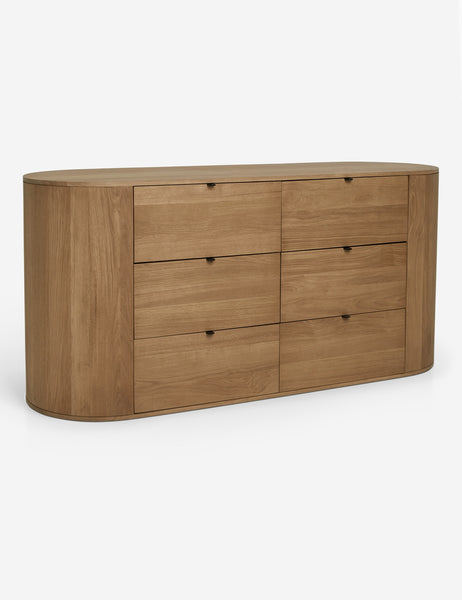 | Angled view of the Kono 6-drawer curved oak wide dresser.